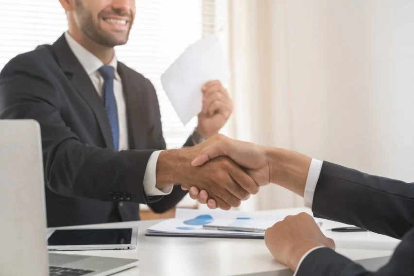 Sell on Comission Two persons shaking hands concluding that they have an understanding and agreement